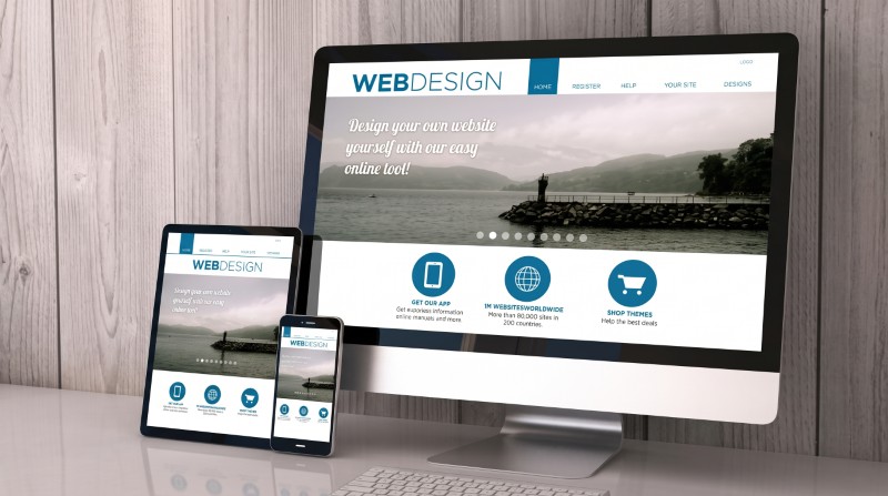 Website design shown on a desktop monitor, tablet and smartphone screens